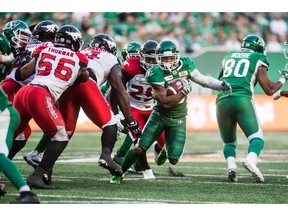 Saskatchewan Roughriders running back Tre Mason (10) runs the ball under pressure from the Calgary Stampeders during second half CFL action in Regina on Sunday, August 19, 2018. The Saskatchewan Roughriders defeated the Calgary Stampeders 40-27.