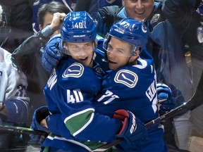 Canucks Nikolay Goldobin (right) and Elias Pettersson after scoring against the Calgary Flames on Wednesday, Oct. 3, 2018 at Rogers Arena in Vancouver.