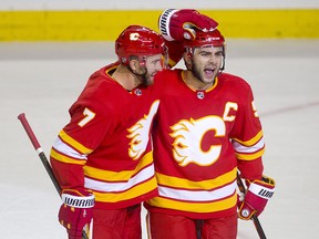 Calgary Flames Mark Giordano, right, celebrates his goal against Vancouver with teammate TJ Brodie at the Scotiabank Saddledome on Oct. 6, 2018.
