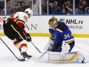 St. Louis Blues goaltender Jake Allen, makes a save on a shot by Calgary Flames' James Neal during the first period Thursday, Oct. 11, 2018, in St. Louis. Neal would score on another chance in a losing cause.