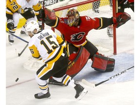 Calgary Flames goalie, Mike Smith makes a save on a Pittsburgh Penguins shot in first period action at the Scotiabank Saddledome in Calgary on Thursday October 25, 2018. Darren Makowichuk/Postmedia