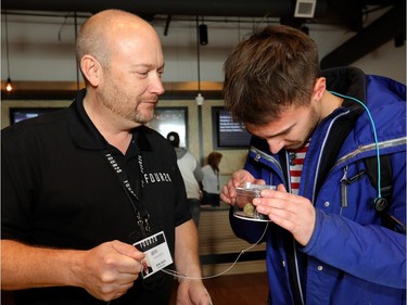 Jeff Mooij, president of Premium Four20 Market, serves a customer on Wednesday, Oct. 17, 2018.