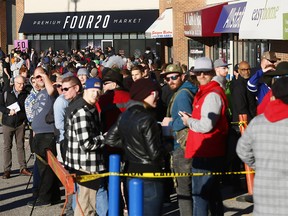 Customers line up outside Premium Four20 Market in Calgary on opening day, Oct. 17, 2018.