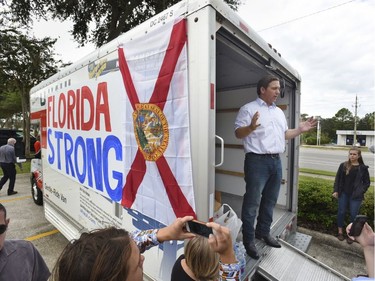 Florida gubernatorial candidate Ron DeSantis combined a campaign stop for supporters with a collection drive for water and canned goods for those in need after Hurricane Michael impending landfall at the Florida Panhandle Wednesday, Oct. 10, 2018, at a shopping center in Jacksonville, Fla.  (Bob Self/The Florida Times-Union via AP) ORG XMIT: FLJAJ101