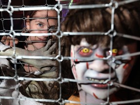 Christine Campbell with some of the many scenes at Haunted Calgary in Rocky Ridge. It was Calgary's largest walk-through haunted yard attraction, but is moving to the New Horizon Mall parkade this year.