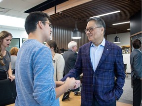 Trico Homes founder Wayne Chiu, right, and student studio member Joe Plant talk at the recent launch of Trico Changemakers Studio at Mount Royal University.