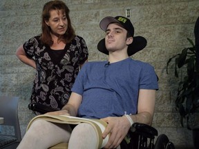Humboldt Broncos hockey player Ryan Straschnitzki, who was paralyzed following a bus crash that killed 16 people, speaks to the media as his mother Michelle, looks on in Calgary, Alta., Wednesday, April 25, 2018.THE CANADIAN PRESS/Jeff McIntosh