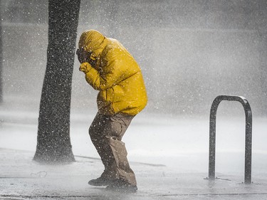 A pedestrian struggles in the wind as he makes his way down Cherry Street on Thursday, Oct. 11, 2018 in Winston-Salem, N.C. The remnants of Hurricane Michael moved northwards after striking the Florida panhandle. (Andrew Dye/Winston-Salem Journal via AP) ORG XMIT: NCWIN101