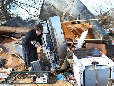 PANAMA CITY BEACH, FL - OCTOBER 11:  Gavin Conklin, 17, gathers water bottles from a neighbor's refrigerator after Hurricane Michael destroyed the home on October 11, 2018 in Panama City, Florida. The hurricane hit the Florida Panhandle as a category 4 storm.  (Photo by Joe Raedle/Getty Images)