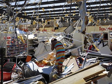 A woman walks through a damaged store in the aftermath of Hurricane Michael in Springfield, Fla., Thursday, Oct. 11, 2018. (AP Photo/David Goldman) ORG XMIT: FLDG106