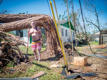 Paul Dean cleans up his property in Panama City, Florida, in the aftermath of Hurricane Michael on October 11, 2018. - Residents of the Florida Panhandle woke to scenes of devastation Thursday after Michael tore a path through the coastal region as a powerful hurricane that killed at least two people. (Photo by Emily KASK / AFP)EMILY KASK/AFP/Getty Images