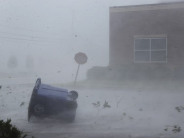 A trash can and debris are blown down a street by Hurricane Michael on October 10, 2018 in Panama City, Florida. The hurricane made landfall on the Florida Panhandle as a category 4 storm.