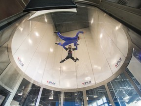 Lauren Grivec, 15, enjoys the sensation of flying with the help of instructor Chris Andrews at iFLY Toronto indoor sky diving centre in Oakville, Ont., on July 16, 2015. iFly is building a similar facility in Calgary.