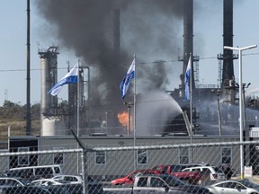 Flame and smoke erupts from the Irving Oil refinery in Saint John, N.B., on Monday, Oct. 8, 2018.