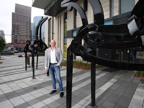 Developer Brad Lamb  with the artwork installation titled Land of Horses by Chilean artist Francisco Gazitua, in front of 6th and Tenth.