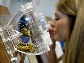 FILE PHOTO: Brianna Koversky sniffs a sample of cannabis at the Nova Cannabis retail outlet in Edmonton on Wednesday, October 17, 2018, the first day that cannabis became legal in the country.