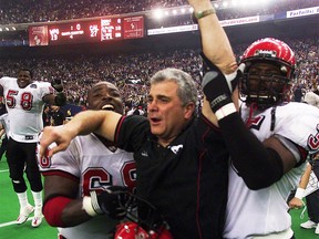 MONTREAL, NOV 25/01-Calgary Stampeders head coach Wally Buono (center) & player Otis Floyd (right) and Fred Childress after winning the 2001 Grey Cup.  PHOTO PIERRE OBENDRAUF/SPORTS * Calgary Herald Merlin Archive *