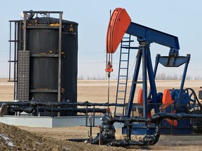 Oil extraction equipment pumps crude out of the ground on a Husky Oil site east of Bruderheim, Alberta on Jan. 11, 2012.