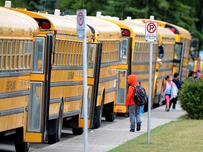 Children board school buses in Mayland Heights in N.E. Calgary. Transport Minister Marc Garneau is ordering his department to take a fresh look at the data on school bus safety and seatbelts.