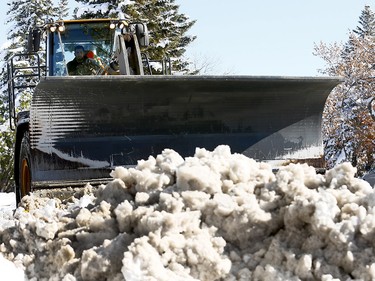 City of Calgary crews work to clear Northmount Drive N.W. on Oct. 3, 2018, one day after a record-breaking snowstorm on Tuesday.