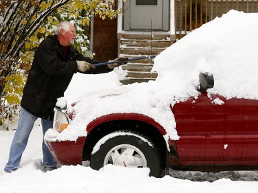 Tom Case clears his car in N.W. Calgary on Tuesday, Oct. 2, 2018.