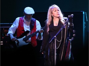 Stevie Nicks (R) and John McVie (L) of Fleetwood Mac perform during the On With the Show Tour 2014 at Canadian Tire Centre in Ottawa on October 26, 2014.