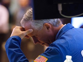 A trader works on the floor at the closing bell of the Dow Industrial Average at the New York Stock Exchange on Wednesday. Wall Street stocks plunged, with major indices losing more than three per cent.