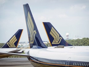 Singapore Airlines Ltd. aircraft sit at Changi Airport in Singapore, on Thursday, March 3, 2016.