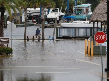 High tide from offshore Hurricane Michael creeps up into the Sponge Docks in Tarpon Springs, Fla., Wednesday, Oct. 10, 2018 after the Anclote River backs up. (Jim Damaske/The Tampa Bay Times via AP) ORG XMIT: FLPET101