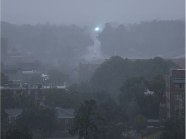 An electric transformer explodes in the distance as heavy rains and wind from Hurricane Michael blanket the Florida State University campus Wednesday, Oct. 10, 2018, in Tallahassee, Fla.