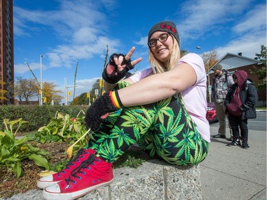 Ashley Beauvais, 30, sits outside the Adult High School on Rochester St wearing her marijuana pants in celebration of the day that cannabis became legal in Canada. But she wasn't smoking during her break from class as she was still on school property.  Photo by Wayne Cuddington/ Postmedia