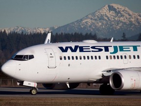 A pilot taxis a Westjet Boeing 737-700 plane to a gate after arriving at Vancouver International Airport on Feb. 3, 2014. WestJet has updated its Alcohol and Drug Policy in preparation for the legalization of cannabis on Oct. 17.