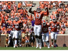 CLEMSON, SC - SEPTEMBER 01: Defensive lineman K.J. Henry #13 of the Clemson Tigers reacts as he runs off the field with teammates safety Nolan Turner #24, linebacker Jalen Williams #30, defensive back Mario Goodrich #31, and defensive end Logan Rudolph #54 after the Tigers force a Furman Paladins fumble during the fourth quarter of the football game at Clemson Memorial Stadium on September 1, 2018 in Clemson, South Carolina.