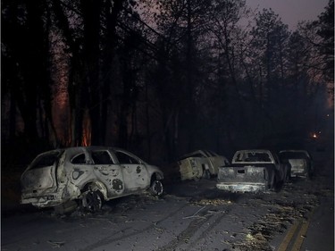 Abandoned burned out cars sit in the middle of the road after the Camp Fire moved through the area on Nov. 8, 2018 in Paradise, California. Fuelled by high winds and low humidity, the rapidly spreading wildfire has ripped through the town of Paradise, charring 18,000 acres and destroying dozens of homes in a matter of hours. The fire is currently at zero containment.