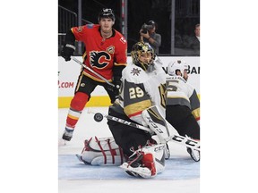 Vegas Golden Knights goalie Marc-Andre Fleury watches the puck sail wide of the net as Matthew Tkachuk #19 of the Calgary Flames waits for a rebound in the first period of their game at T-Mobile Arena on Friday in Las Vegas.
