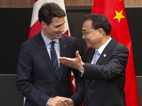 Canadian Prime Minister Justin Trudeau meets with Chinese Premier Li Keqiang before the Canada-China Annual Leaders dialogue in Singapore on Nov. 14, 2018. Canada is advised not to negotiate trade deals with China in isolation from its U.S. and EU trading partners, says columnist.