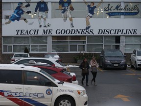 Parents, police and security were guarding the back entrance of St. Michael's College in Toronto.