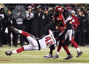 The Calgary Stampeders' Chris Matthews (81) is tackled by the Ottawa Redblacks' Avery Williams (42) and Anthony Cioffi (24) during second half Grey Cup action at Commonwealth Stadium, in Edmonton Sunday November 25, 2018. Calgary won 27 to 16.  Photo by David Bloom
