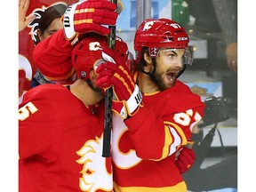 The Calgary Flames' Michael Frolik celebrates with Mark Giordano after Frolic scored his second goal of the night during NHL second period action against the Boston Bruins at the Scotiabank Saddledome in Calgary on Wednesday October 17, 2018. Gavin Young/Postmedia