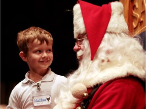 Lawyer Steve Major has a long list of topical requests for Santa Claus. Pictured here, kindergarten student Matthew Miller gets a chance to chat with St. Nick at Santa school in Michigan.