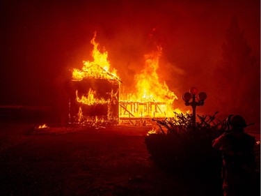 A home burns as the Camp fire tears through Paradise, California on November 8, 2018. More than 18,000 acres have been scorched in a matter of hours burning with it a hospital, a gas station and dozens of homes.