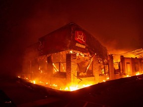 A Jack In The Box restaurant burns as the Camp fire tears through Paradise, north of Sacramento, Calif., on Nov. 08, 2018. More than 100 homes, a hospital, a Safeway store and scores of other structures have burned in the area.
