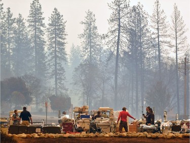 Search and rescue teams scramble to evacuate patients as the Feather River Hospital burns during the Camp fire in Paradise, California on Nov. 8, 2018. A rapidly spreading, late-season wildfire in northern California has burned 20,000 acres of land and prompted authorities to issue evacuation orders for thousands of people.