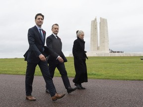 Canadian Prime Minister Justin Trudeau, Minister of Veterans Affairs Seamus O'Regan and Canadian Ambassador to France Isabelle Hudon walk past the memorial at Vimy Ridge, France following a ceremony Saturday.