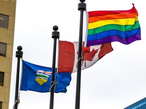 The Pride flag flies with the Canadian and Alberta flags after a flag raising to celebrate Pride Week outside the McDougall Centre in Calgary on Monday August 27, 2013.  Gavin Young/Postmedia
