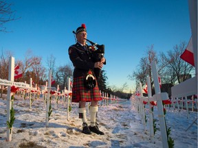 Piper Frank Neelands with the Calgary Police Service Pipe Band played at the Field of Crosses sunset flag lowering ceremony on Wednesday November 7, 2018. The sunrise and sunset ceremonies continue through Remembrance Day.  Gavin Young/Postmedia