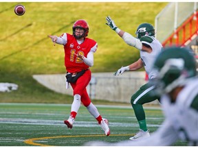 University of Calgary Dinos quarterback Adam Sinagra passes during the Hardy Cup against University of Saskatchewan Huskies at McMahon Stadium on Saturday. The Huskies won the game 43-18. Gavin Young/Postmedia