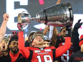 Calgary Stampeders quarterback Bo Levi Mitchell raises the Grey Cup after defeating the Ottawa Redblacks at Commonwealth Stadium in Edmonton on Sunday November 25, 2018.  Gavin Young/Postmedia