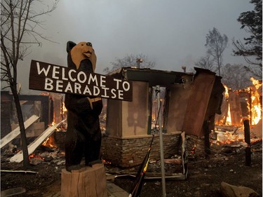 Flames consume a building as the Camp Fire tears through Paradise, Calif., on Thursday, Nov. 8, 2018. A California fire official says a fast-moving wildfire in Northern California has destroyed structures and injured civilians.