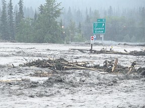 Flood waters from Cougar Creek overtake the Trans-Canada Highway in Canmore on Thursday morning, June 20, 2013. Justin Parsons/Postmedia Archives